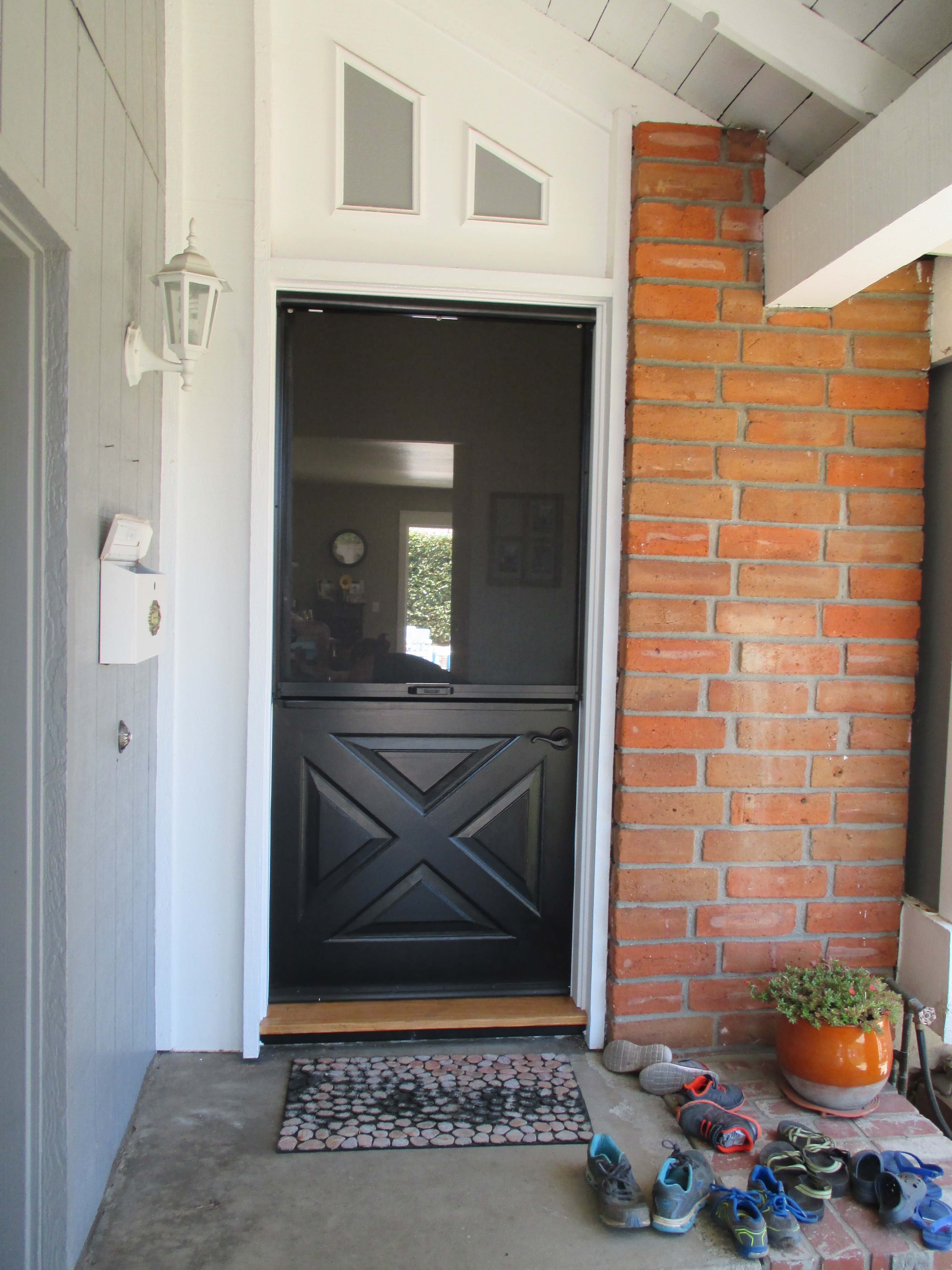 Woman Standing in Screen Doorway